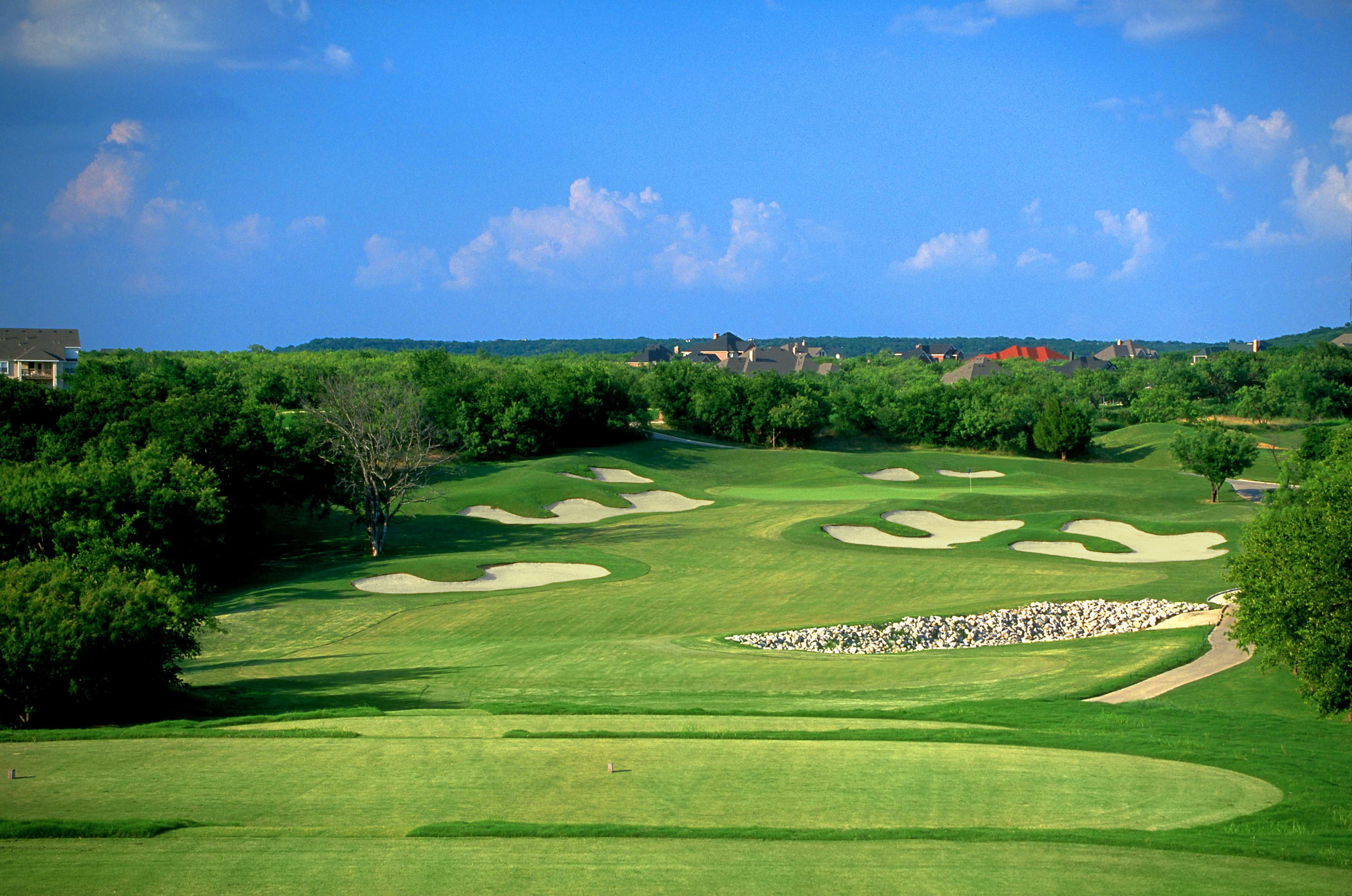 Fairway lined with trees and sand bunkers